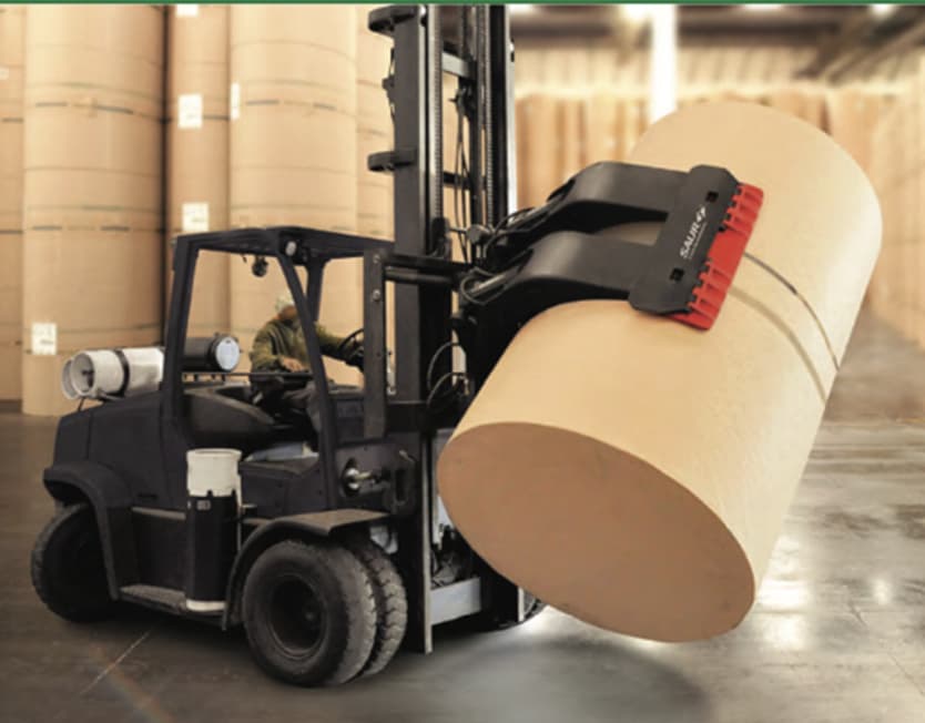 Forklift with a Saur paper roll clamp lifting a paper roll in a warehouse