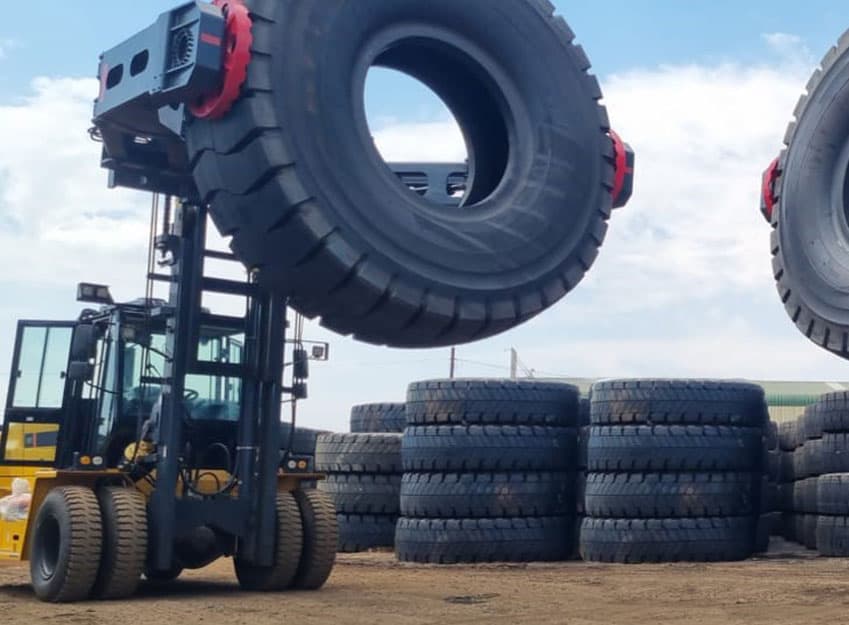 Tyre handler positioning a large industrial tyre